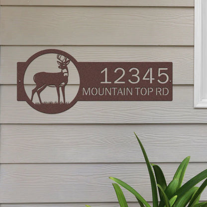 Candy copper address sign with deer on right and '12345 Mountain Top Rd' on left in bold, easy-to-read lettering.
