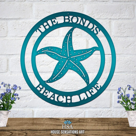 Personalized Starfish sea star sign displayed on a white brick wall, showcasing its elegant design. Ideal for outdoor address signage, this weather-resistant custom metal sign enhances coastal-themed decor.