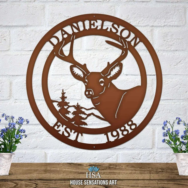 Candy copper metal sign on light brick wall with deer head, pine tree, “EST 1988” and “DANIELSON” cut into the border.