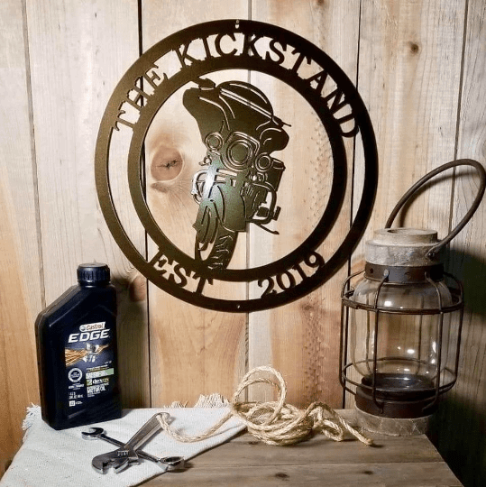 Custom Metal Motorcycle Sign on a table with a motor oil bottle and wrench, showcasing weather-resistant design ideal for home decor and gifts from HouseSensationsArt.