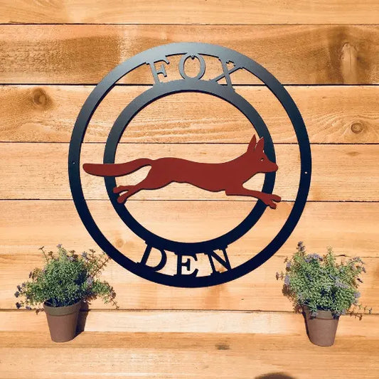 Two-Color Fox Ranch Sign featuring a fox design on a wooden background, alongside potted plants, illustrating its suitability as a customizable, weather-resistant outdoor address sign and housewarming gift.