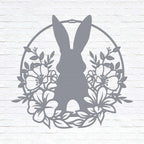 Custom Easter bunny metal wall sign with floral wreath, powder coated outdoor spring décor, rabbit silhouette front door decoration, farmhouse-style Easter wall art on white brick background, pastel seasonal accent
