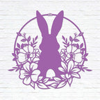Purple Easter bunny metal wall sign with floral wreath design, custom rabbit silhouette front door décor, powder coated outdoor spring decoration, farmhouse-style Easter wall art on white brick background