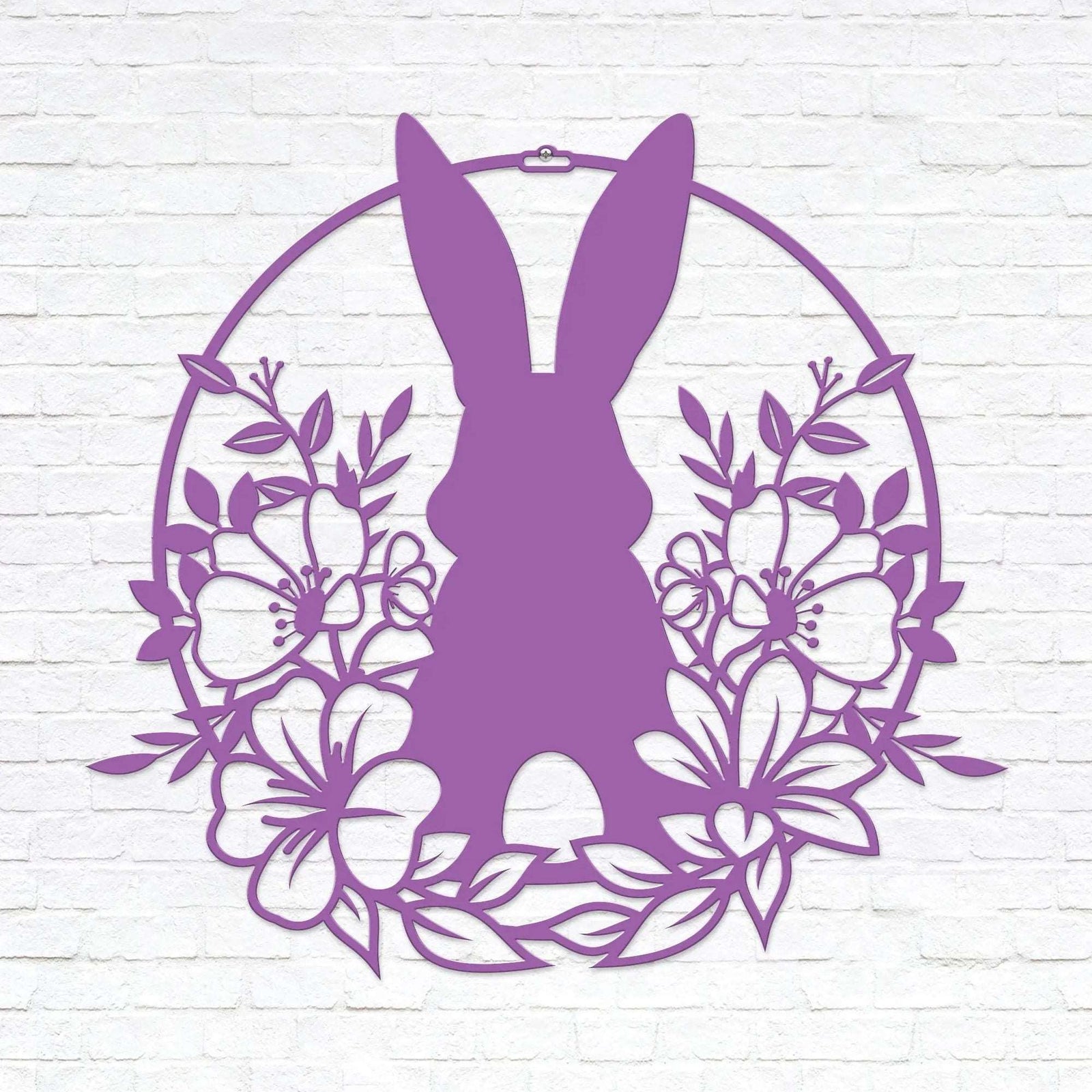 Purple Easter bunny metal wall sign with floral wreath design, custom rabbit silhouette front door décor, powder coated outdoor spring decoration, farmhouse-style Easter wall art on white brick background