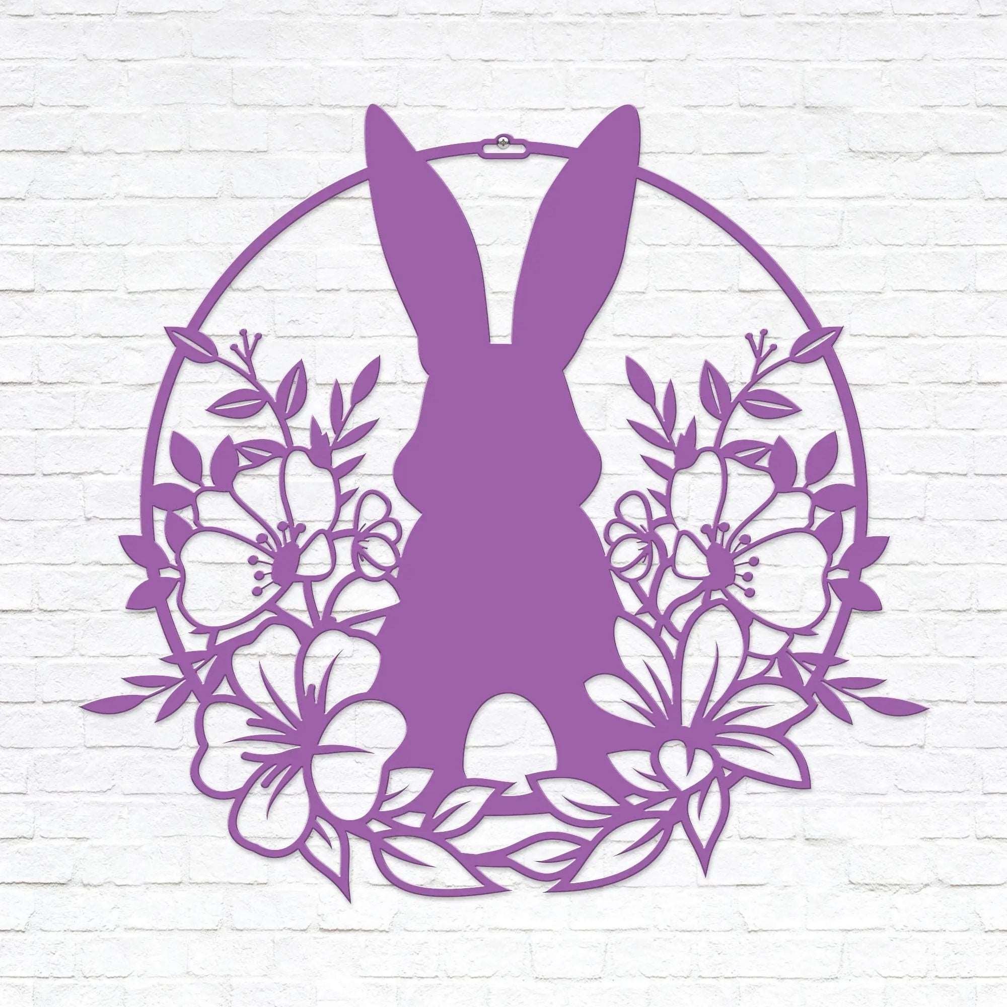 Purple Easter bunny metal wall sign with floral wreath design, custom rabbit silhouette front door décor, powder coated outdoor spring decoration, farmhouse-style Easter wall art on white brick background