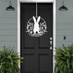 White Easter bunny metal door sign with floral wreath design, custom rabbit silhouette front door décor, powder coated outdoor metal sign, spring porch decoration with greenery, farmhouse Easter door hanger on black door