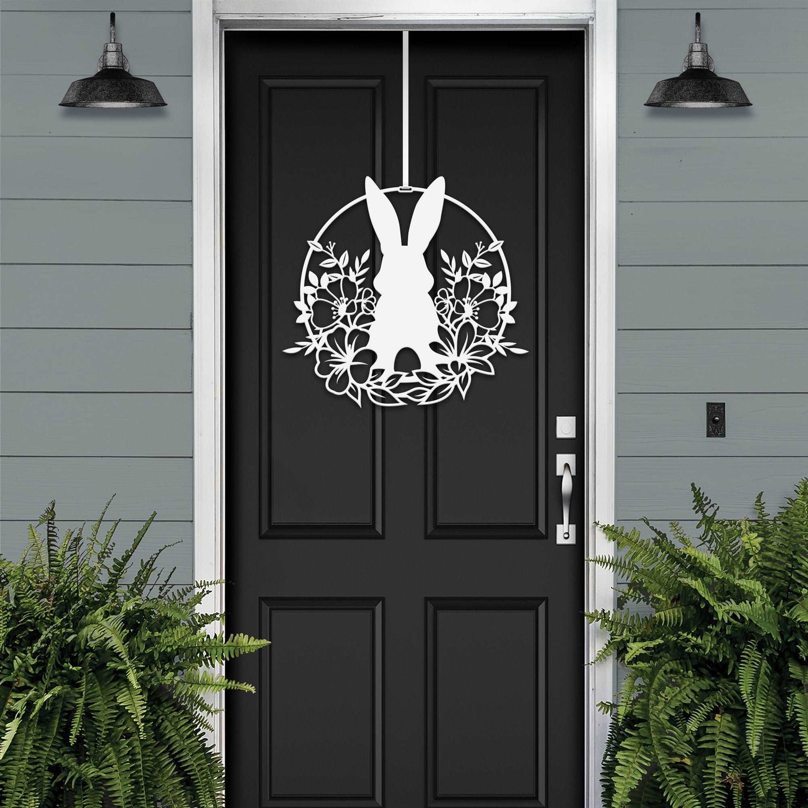 White Easter bunny metal door sign with floral wreath design, custom rabbit silhouette front door décor, powder coated outdoor metal sign, spring porch decoration with greenery, farmhouse Easter door hanger on black door