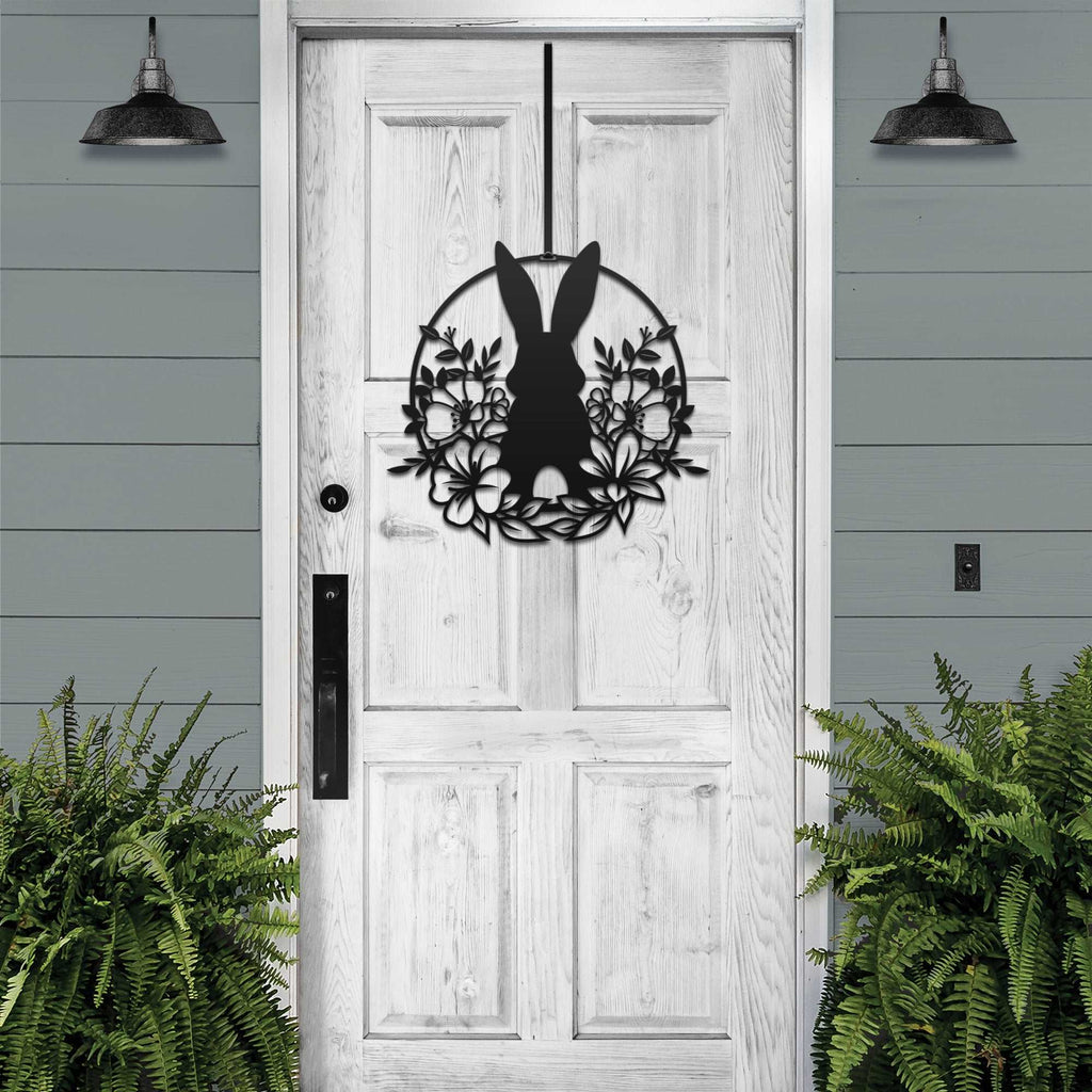 Matte black Easter bunny metal door sign, custom rabbit silhouette front door décor, powder coated outdoor spring decoration with greenery, farmhouse-style Easter porch sign on wooden door