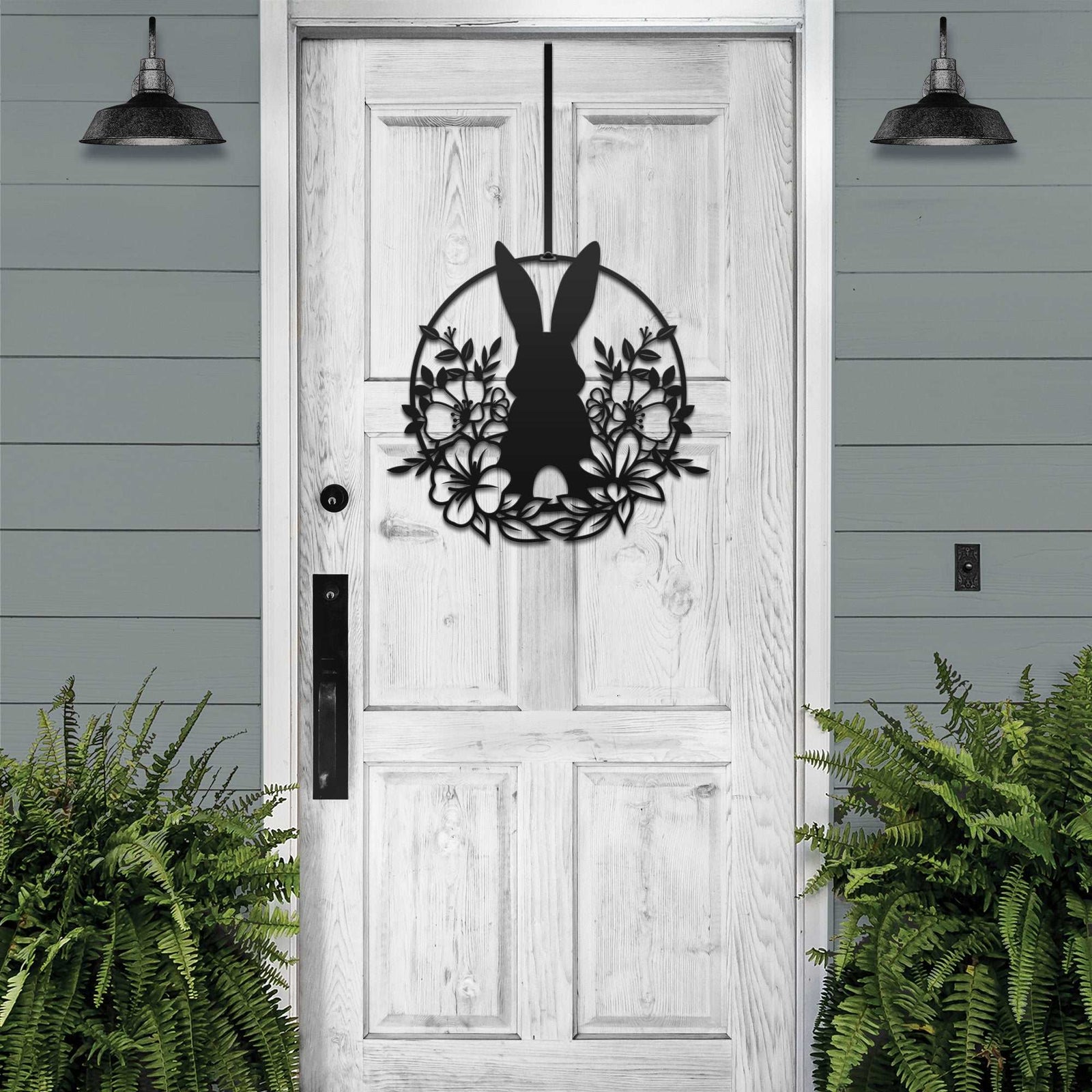 Matte black Easter bunny metal door sign, custom rabbit silhouette front door décor, powder coated outdoor spring decoration with greenery, farmhouse-style Easter porch sign on wooden door
