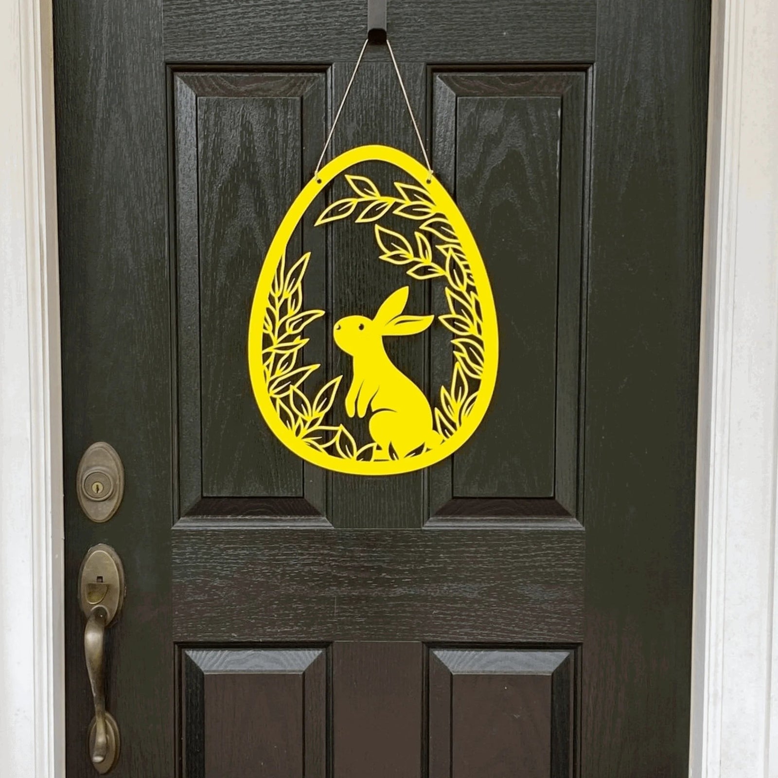 Yellow Easter bunny door hanger on dark wooden door, custom outdoor metal Easter décor, powder coated spring front door sign, farmhouse holiday decoration