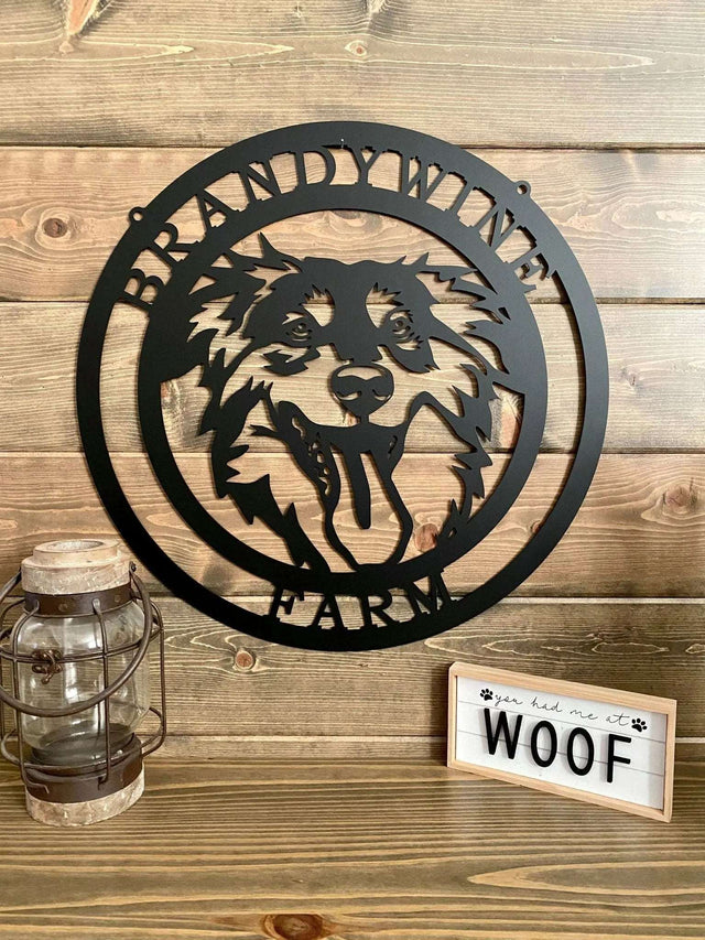 Black custom laser cut metal ranch sign with dog head silhouette and “BRANDYWINE FARM” text; mounted on paneled wall.