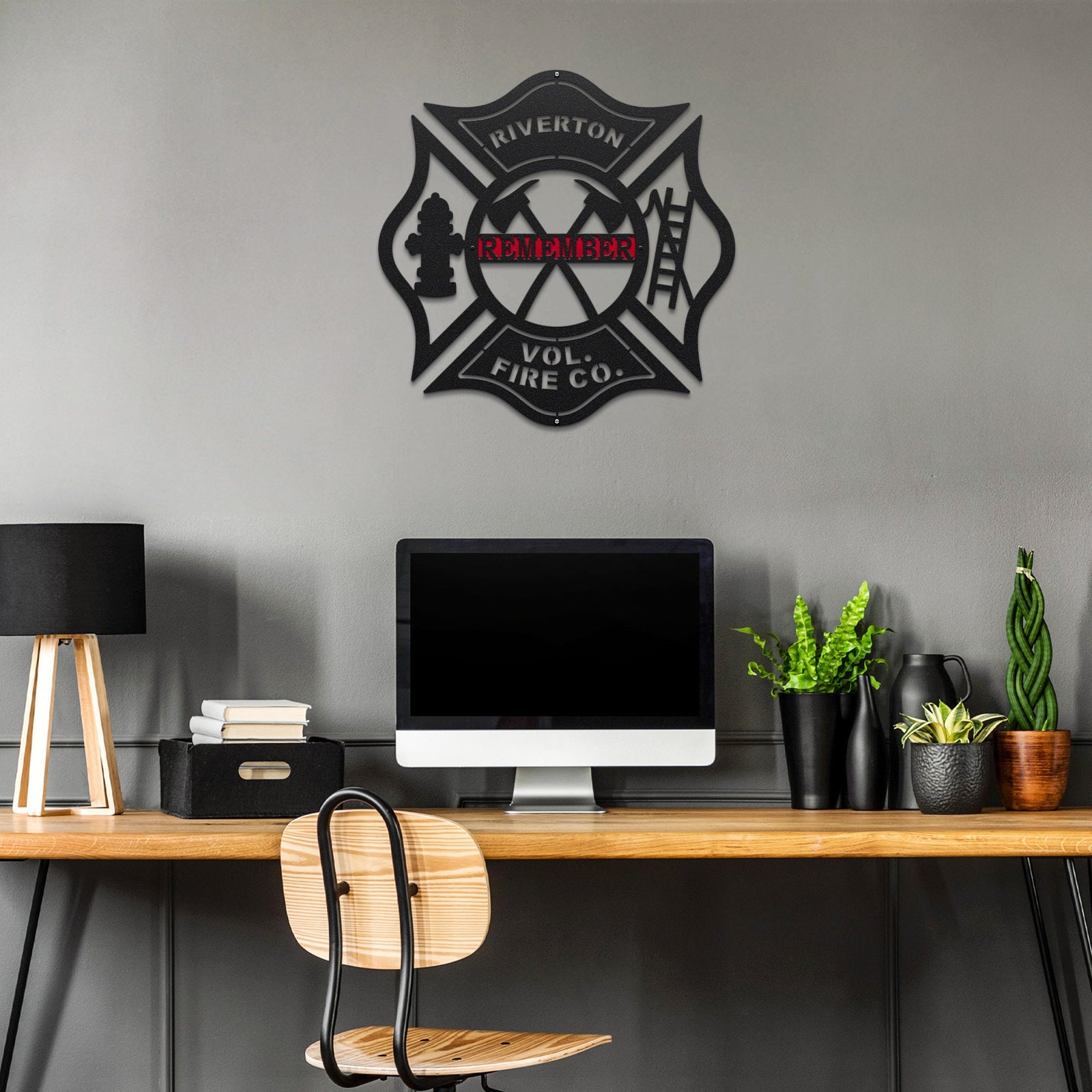Personalized firefighter metal wall sign displayed on ca gray wall above a computer table