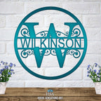 Personalized decorative metal family monogram sign for the last name “WILKINSON,” displayed on a white brick wall, showcasing elegant design and durable craftsmanship by House Sensations Art.