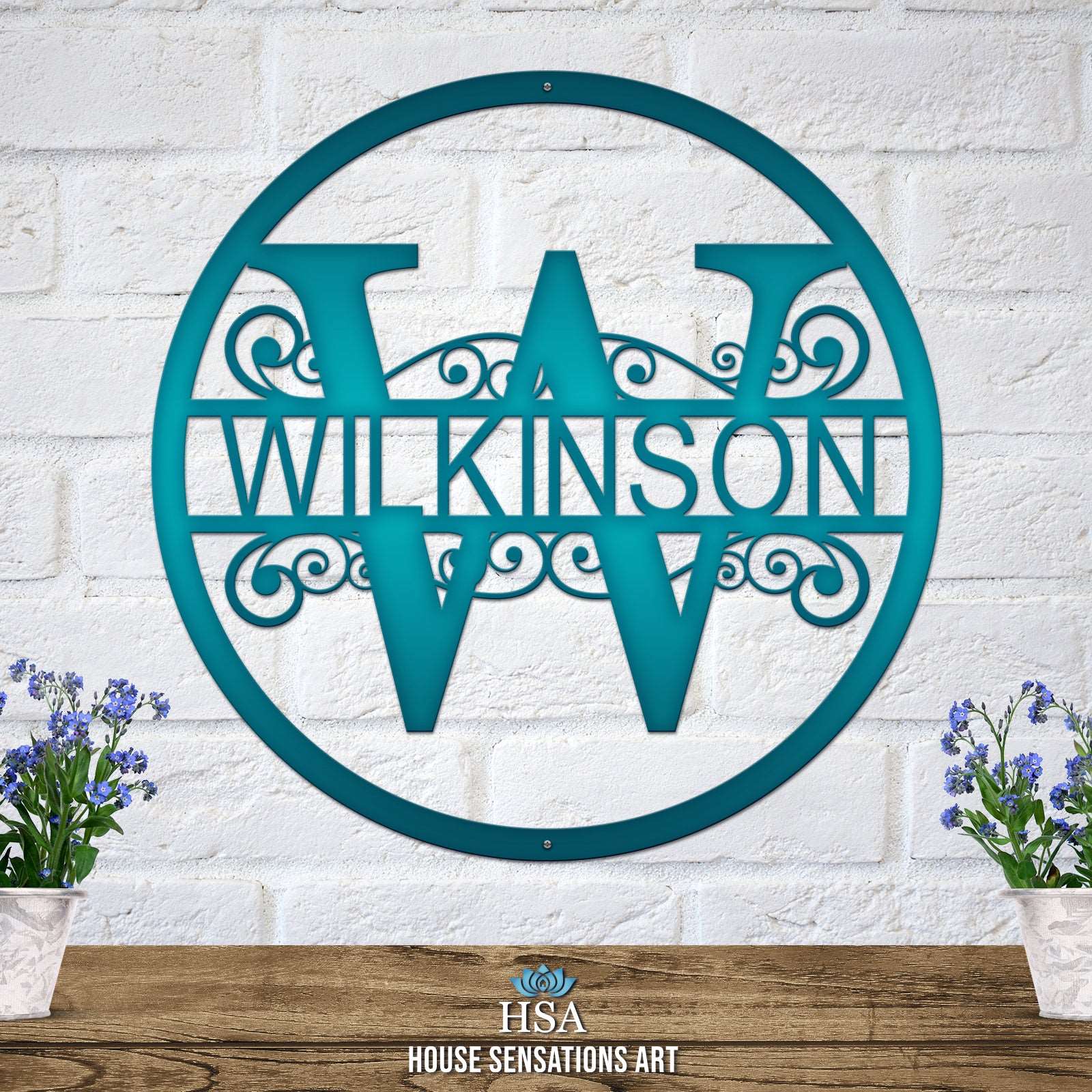 Personalized decorative metal family monogram sign for the last name “WILKINSON,” displayed on a white brick wall, showcasing elegant design and durable craftsmanship by House Sensations Art.