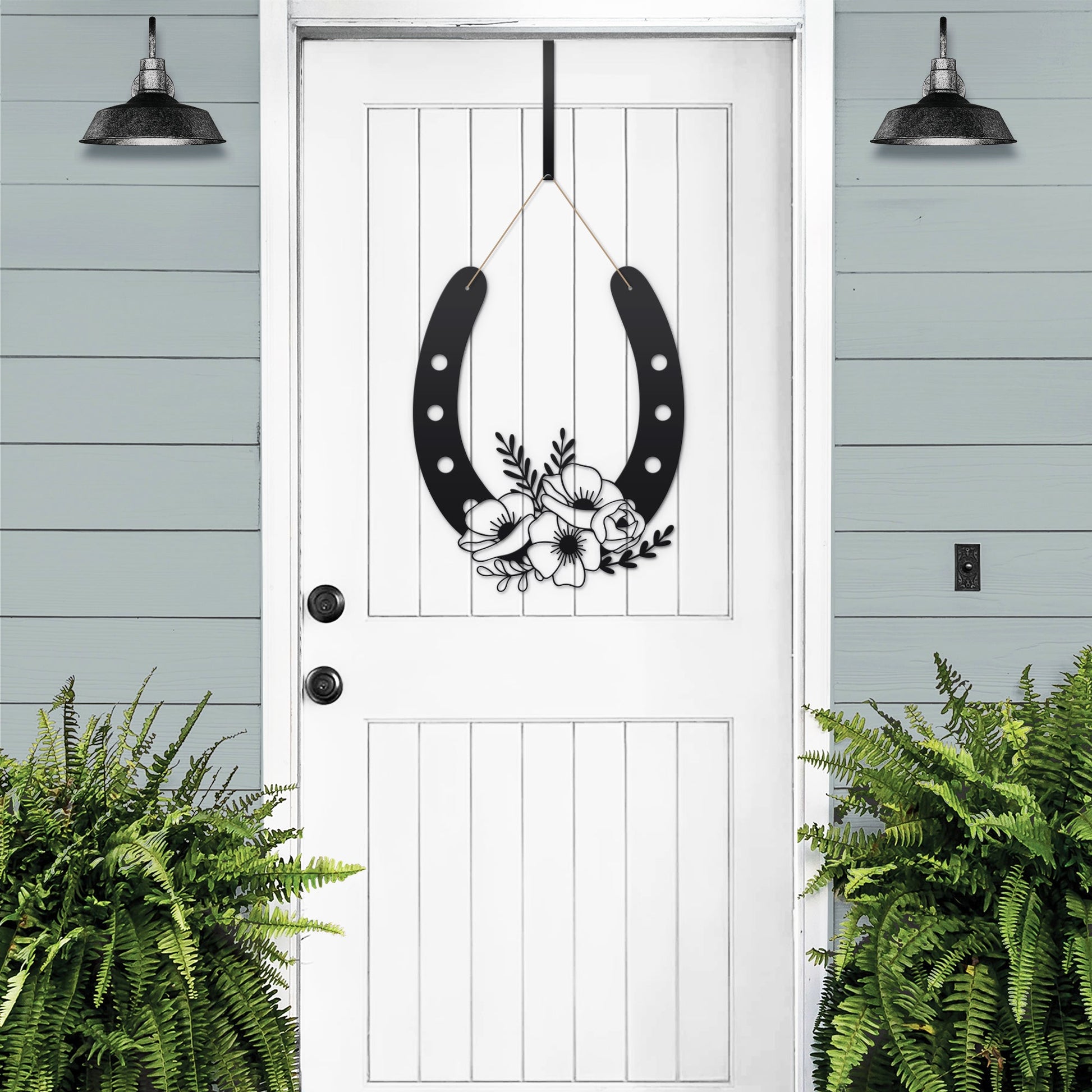 Floral Horseshoe Door Wreath – black rustic metal horseshoe with floral accents for outdoor country decor.