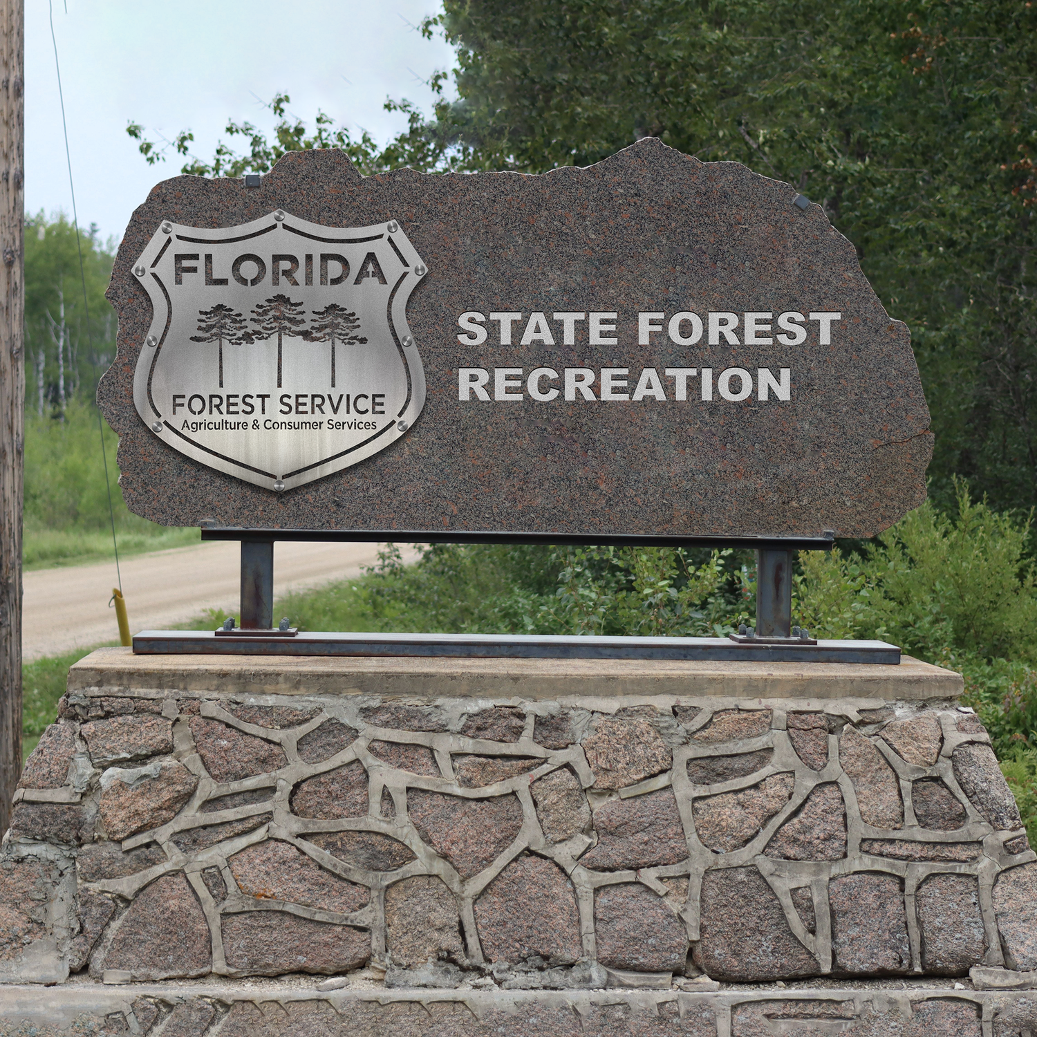 Florida State Forest Recreation sign on a stone base with trees in the background