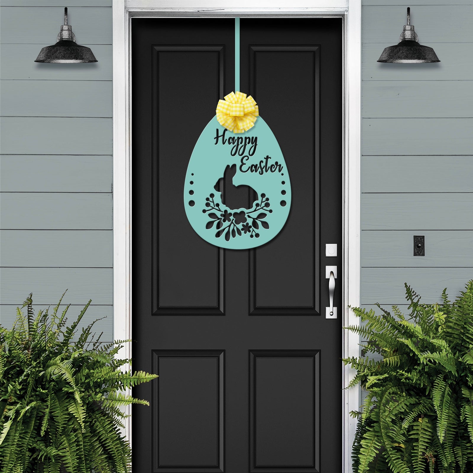 Black front door with floral Easter metal sign, gray exterior wall and green plants, seasonal farmhouse entry décor, custom powder coated welcome wall art sign