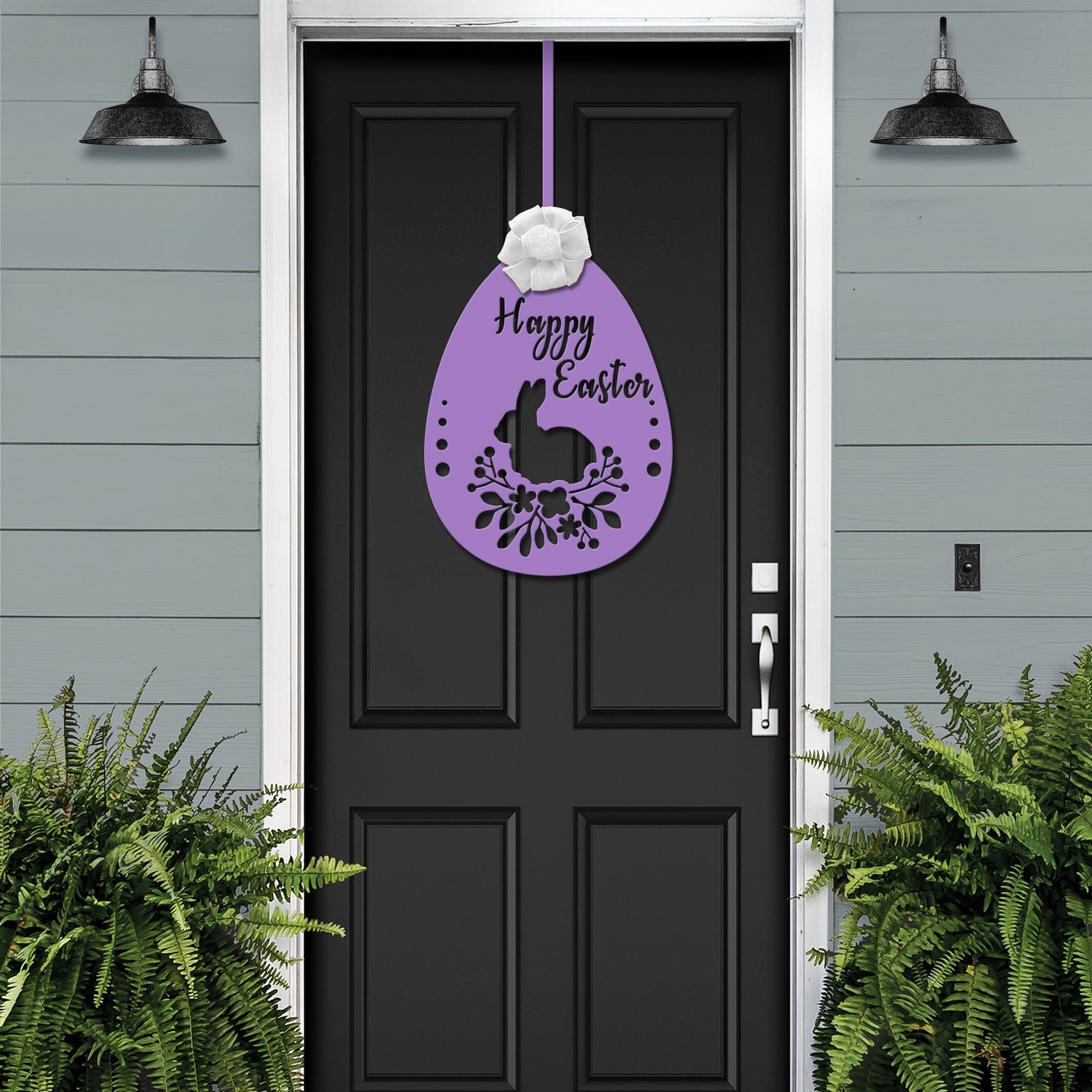 Black front door with purple Easter egg metal welcome sign, gray exterior wall and green plants, seasonal farmhouse décor, custom powder coated entry wall art sign