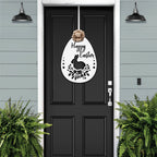 Black front door with Easter bunny metal egg wreath sign, light blue wall background, seasonal farmhouse entry décor, custom powder coated welcome wall art sign