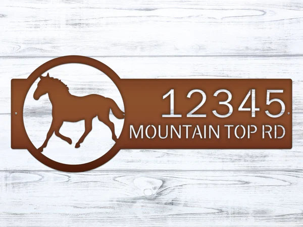 Close up Candy copper metal address sign featuring a  horse silhouette on the right and the custom address '12345 Mountain Top Rd' on the left, with bold, easy-to-read text.