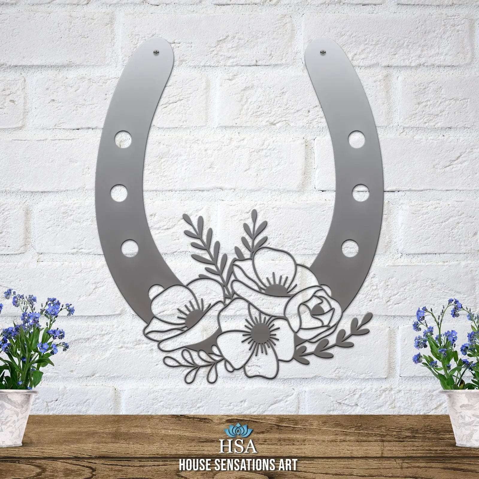 Silver floral horseshoe metal wall art on white brick wall, lucky farmhouse décor, House Sensations Art HSA branded decorative home sign