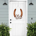Bronze floral horseshoe wall art on white door, lucky farmhouse décor, decorative home sign, light blue background, gift horseshoe design