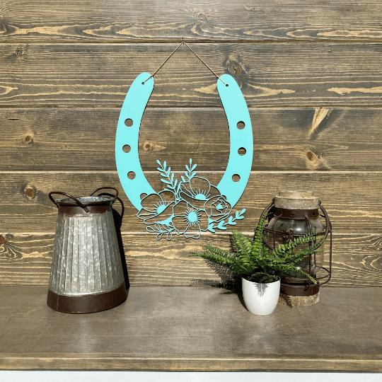 Teal floral horseshoe metal décor on wood shelf with lanterns and plant, rustic lucky farmhouse wall art, decorative home gift sign