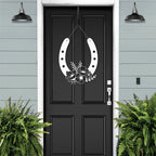 Floral horseshoe metal wall art on black door, lucky farmhouse décor, decorative home sign, blue wall background, gift horseshoe design