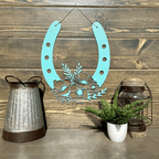 Decorative teal metal horseshoe with floral design on wood wall, rustic home décor, lucky horseshoe sign, farmhouse wall art, gift idea
