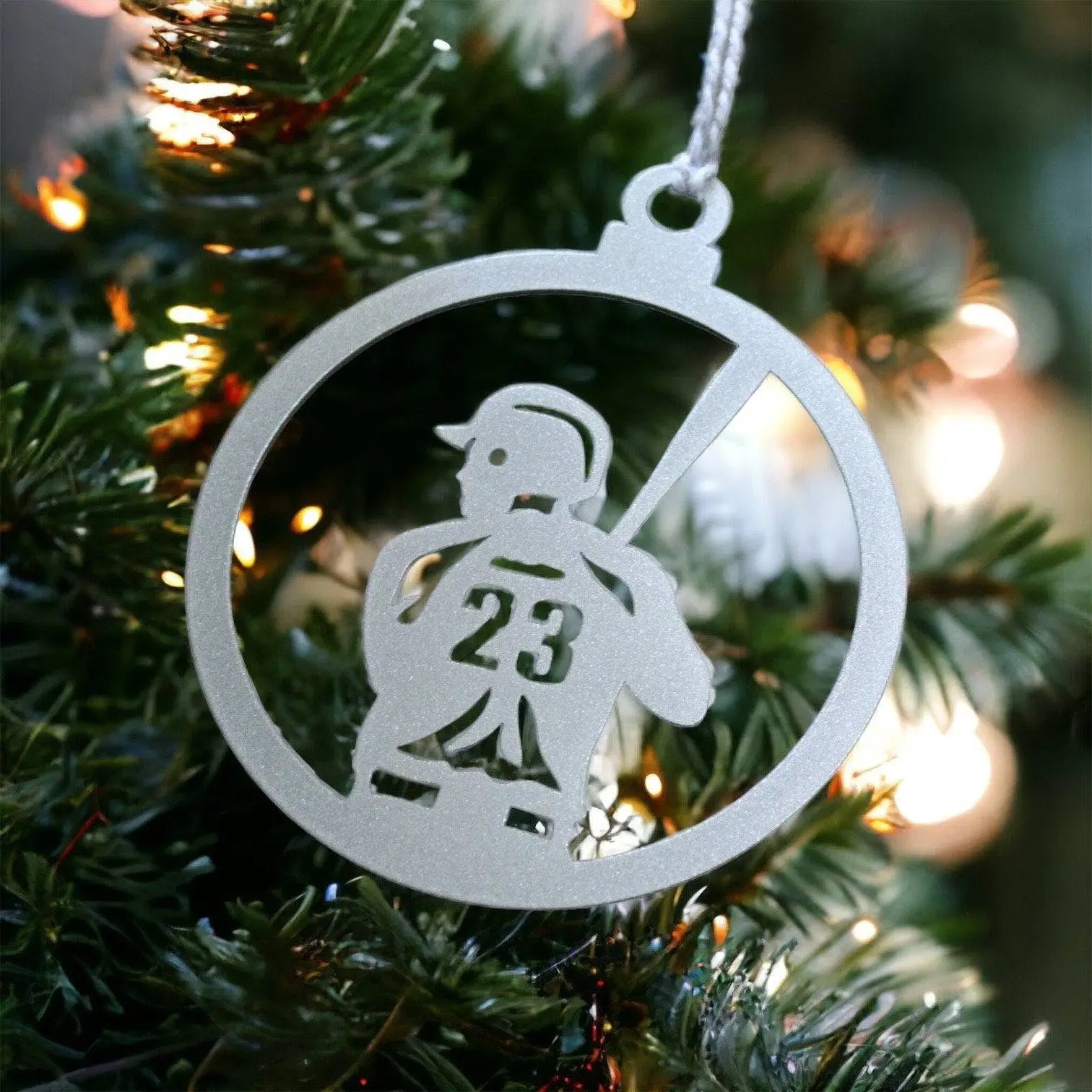 Personalized Baseball Ornament: A silver metal ornament featuring a baseball player design, perfect for adding sporty charm to your Christmas tree. Includes a string for easy hanging.