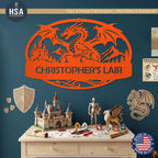 Personalized Dragon Name Plaque: Custom Bold Line Dragons Kids Room Decor - An oval shaped custom metal sign featuring a mythical dragon with wings spread, with medieval castle and scenic mountain background. Features personalized name and is shown in Orange in dragon themed kids bedroom. above castle lego set. and kights display.