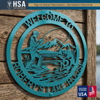 Round teal personalized custom metal sign featuring a fisherman casting over water; lake house entryway decor.