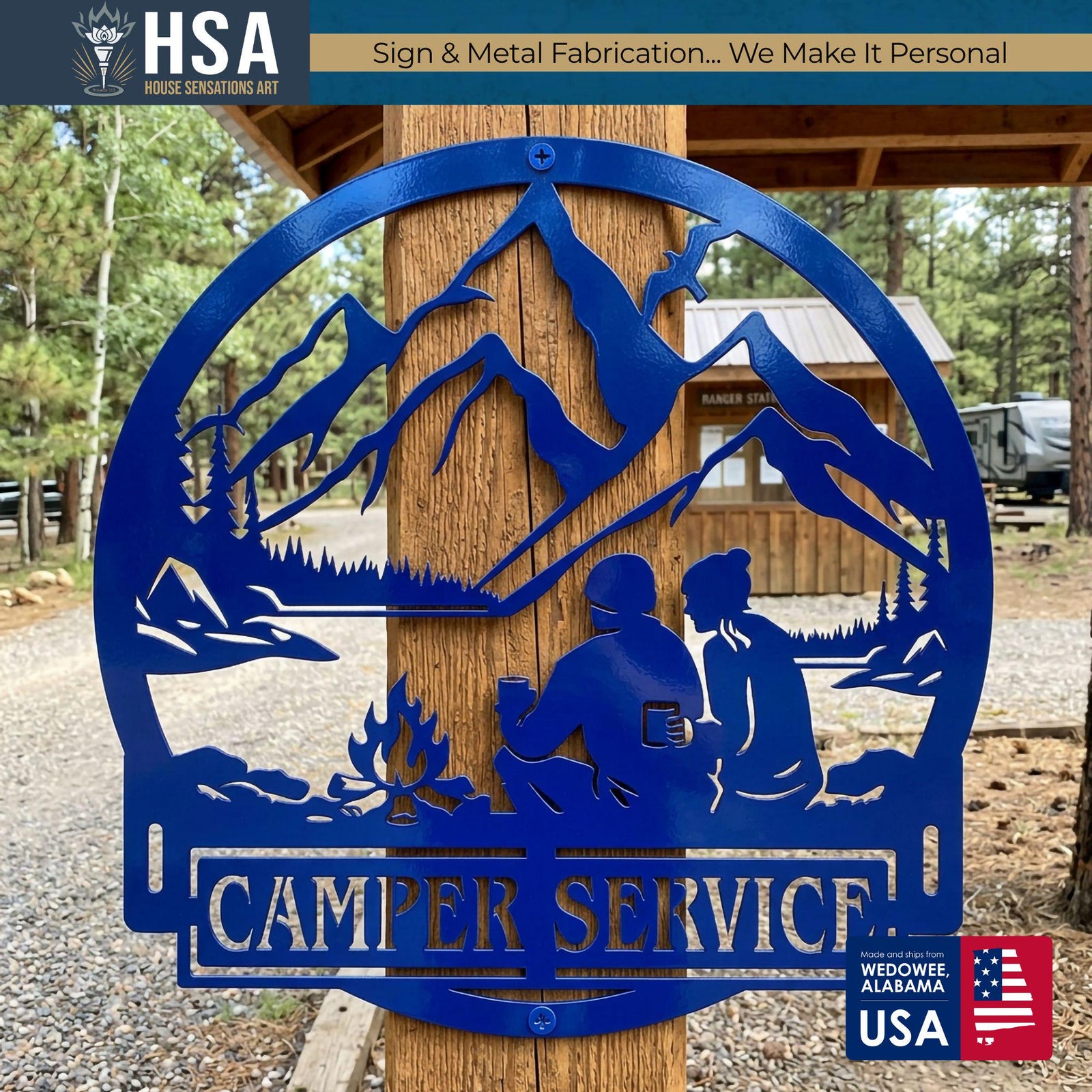 Blue circular metal camper name sign with a camping couple by a campfire, mountains and pines, reading CAMPER SERVICE for RV decor.