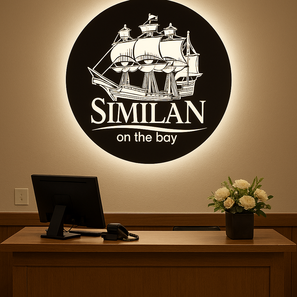 Indoor corporate logo sign with precision-cut metal lettering and soft LED backlighting for a modern aesthetic.