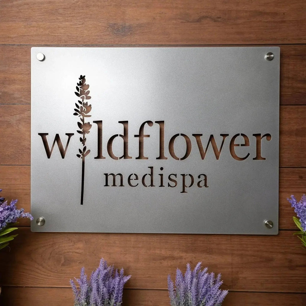 Large custom metal business logo sign for “Wildflower Medispa” on wooden background with lavender, personalized laser-cut office and storefront décor, suitable for company logo displays.