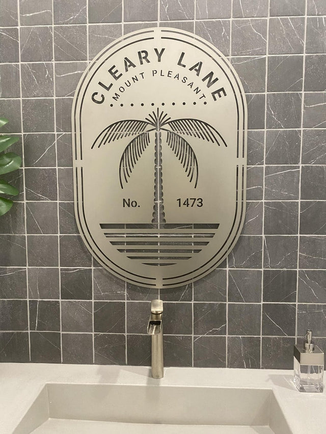 Oval steel sign with bold “CLEARY LANE,” palm tree graphic, and “MOUNT PLEASANT” and “No. 1473” below.