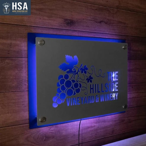 Decorative metal sign with LED backlight for The Hillside Vineyard & Winery with engraving on a wooden background