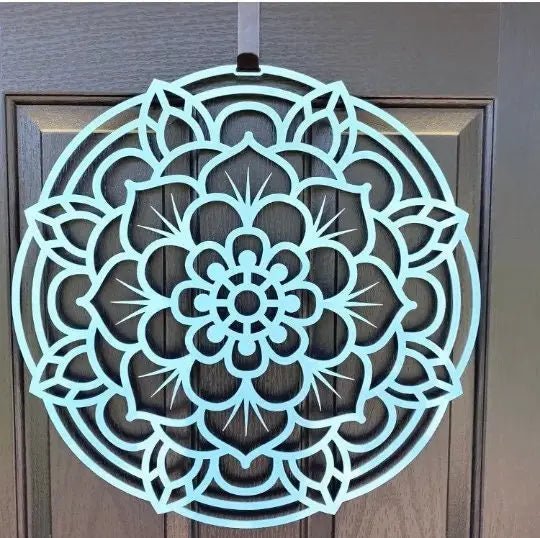 Decorative teal mandala wall art displayed on a wooden door, showcasing intricate lotus flower-inspired design and durable metal craftsmanship for stylish outdoor décor.