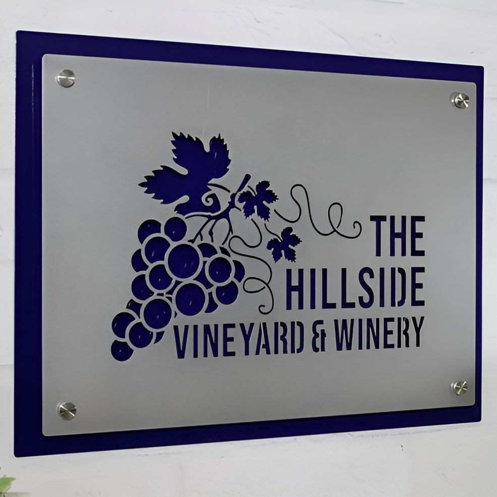 Metal sign featuring “The Hillside Vineyard & Winery” logo displayed on a white background, showcasing crisp, professional branding and durable metal construction.