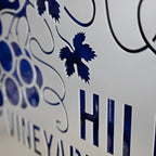 Decorative metal sign featuring a blue and white design with the word “Hill,” showcasing vibrant colors and durable metal craftsmanship.