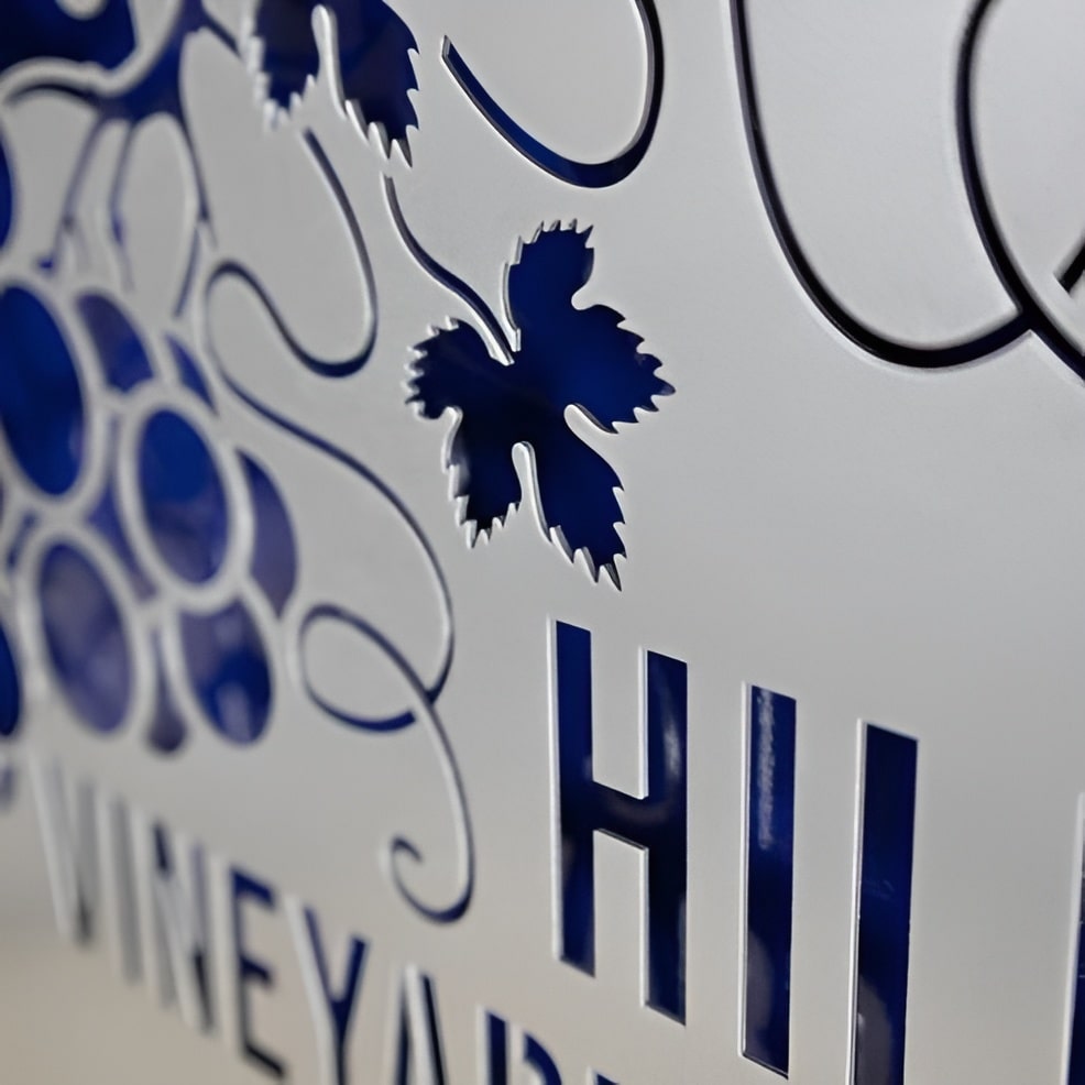 Decorative metal sign featuring a blue and white design with the word “Hill,” showcasing vibrant colors and durable metal craftsmanship.