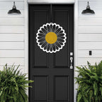 Black door with sunflower design metal sign or decal on white wooden wall, decorative outdoor home entrance accent
