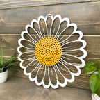 Decorative metal wall art featuring daisy flower design on wooden background, custom indoor or outdoor home décor accent