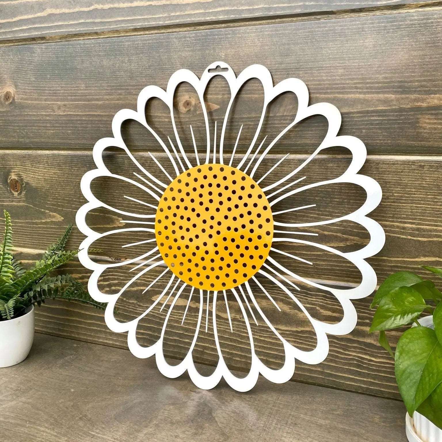 Decorative metal wall art featuring daisy flower design on wooden background, custom indoor or outdoor home décor accent