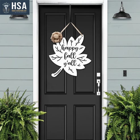 A metal wreath with the text "Happy Fall Y'All"