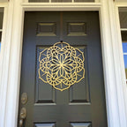Gold floral mandala metal door knocker on gray door, low angle view, custom powder coated entry décor, farmhouse style front door accent, elegant metal hardware design