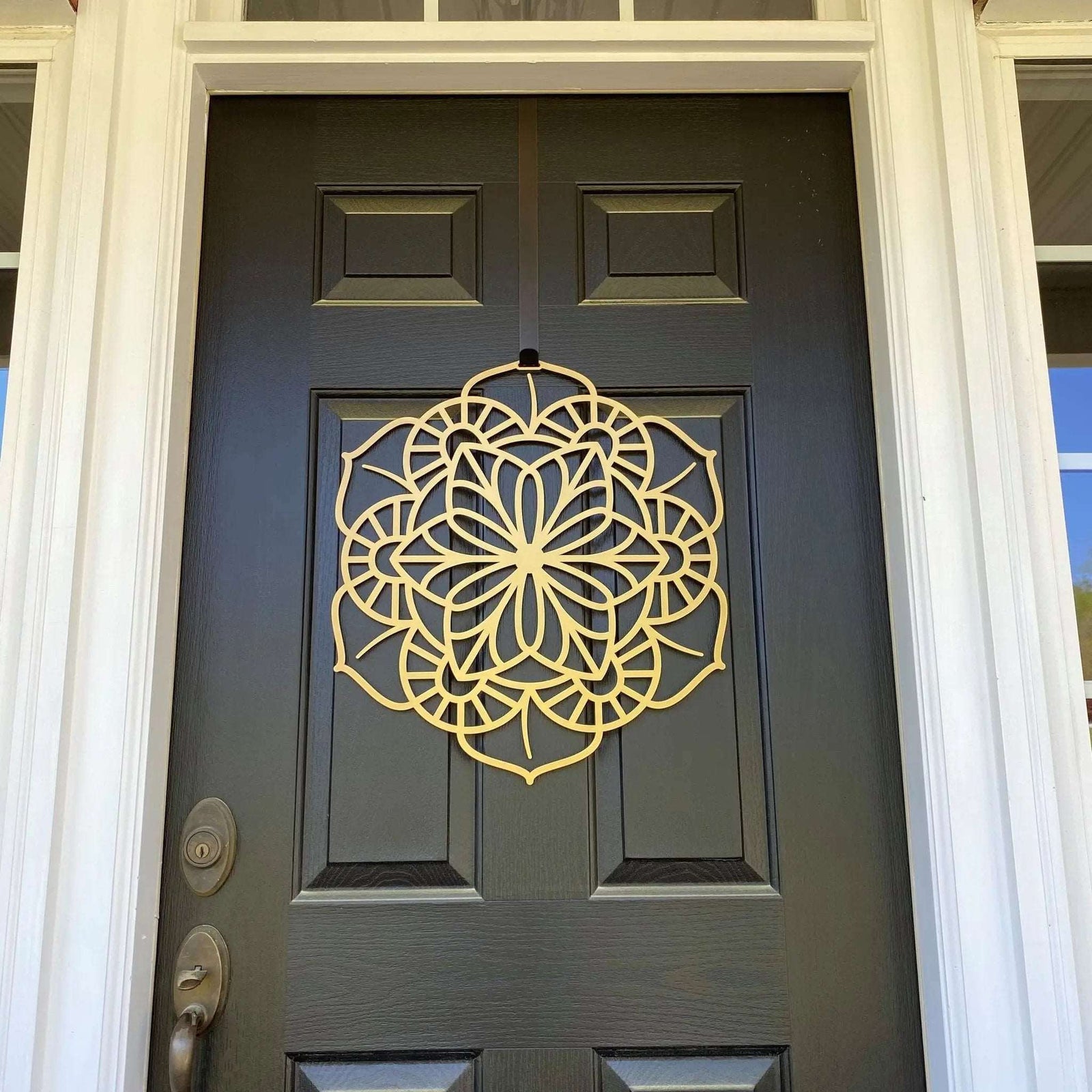 Gold floral mandala metal door knocker on gray door, low angle view, custom powder coated entry décor, farmhouse style front door accent, elegant metal hardware design
