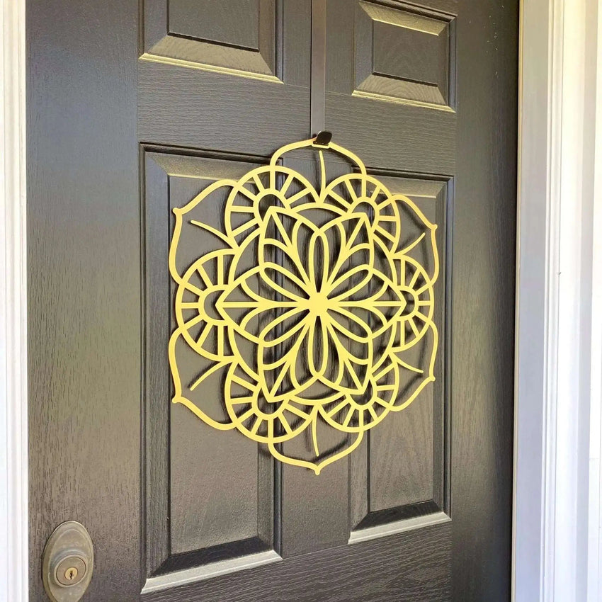 Yellow floral mandala metal wreath on dark wood door, side angle view, custom powder coated front door décor, farmhouse entry welcome wall art sign design