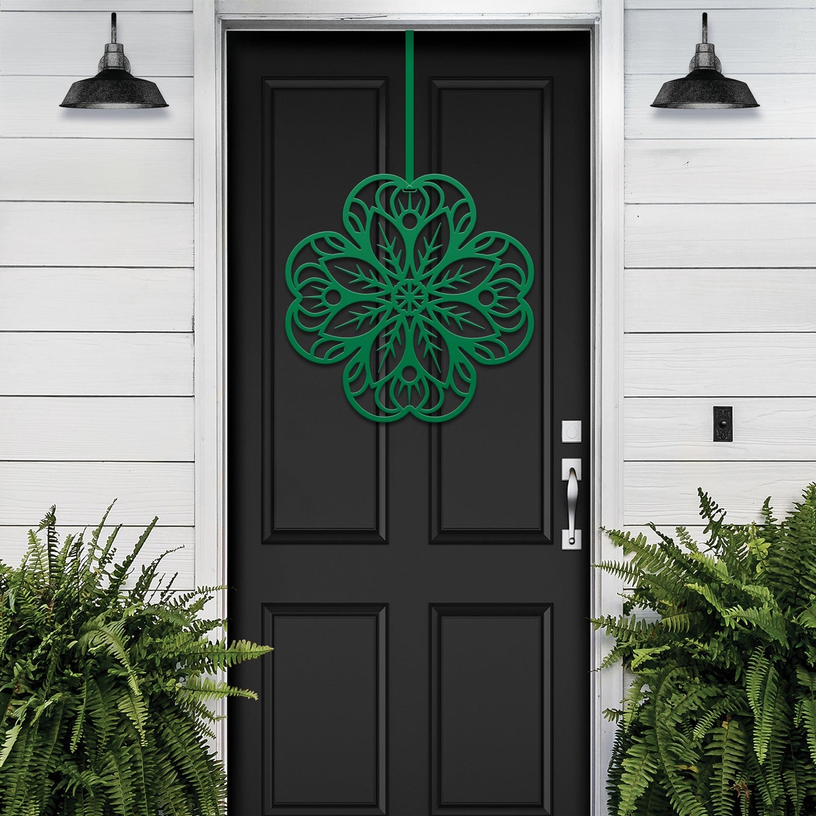 Black front door with green floral mandala metal wall hook décor, white exterior wall with green plants, custom powder coated farmhouse entry accent, elegant welcome sign design