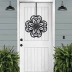 Black floral mandala metal wall art on white front door, green plants exterior, custom powder coated farmhouse entry décor, elegant welcome sign design